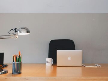 silver apple macbook on brown wooden table