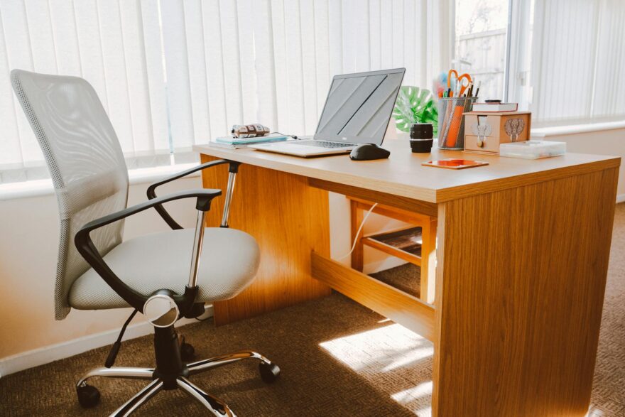 white rolling armchair beside table