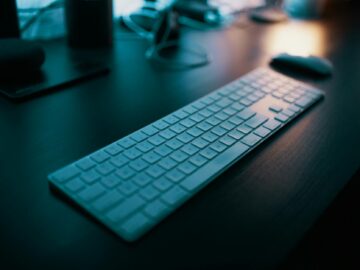 apple magic keyboard with numeric pad on table near wireless mouse