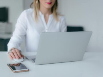 woman using silver laptop