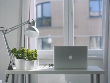 silver macbook air and goose neck lamp