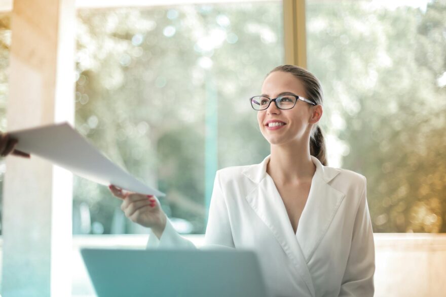 positive businesswoman doing paperwork in office